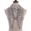 Detail of grey lace triangle scarf with yellow daisy print and crochet tassel edge - Gray