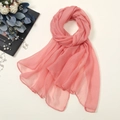 Detail showing pink chiffon scarf with fine hemmed edges and lightweight texture - Grapefruit Red