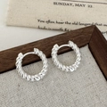Detailed view of silver twisted rope hoop earrings on a vintage fabric background - Silver Twisted Stud Earrings / Silver