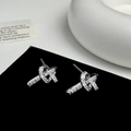 Close-up of silver knot stud earrings with shimmering pave-set cubic zirconia stones - Silver Knot Stud Earrings