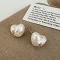 Detailed shot of heart-shaped pearl earrings with gold foil and vintage texture - Large Heart Cotton Pearl Stud Earrings