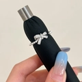 Detailed macro view of silver bow ring with shimmering cubic zirconia and white pearls - Silver Bow Knot Pearl Ring / Silver