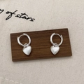 Close-up of silver heart drop earrings with matte finish on a wooden display stand - Heart Pendant Style (A-937)