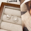 Detailed view of silver matte brushed hoop earrings with round donut charms on a tray - Donut Pendant Style (A-913)