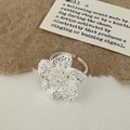 Detail of silver textured flower ring with five petals and adjustable open band design - Silver Flower Ring