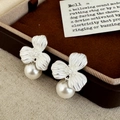 Detail shot of silver-toned flower petal earrings with textured metal and white pearls - Silver Flower Single Large Pearl Style