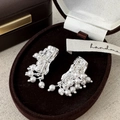 Detailed view of silver wrinkled metal earrings with white pearls on brown velvet tray - Pearl Stud Earrings / Silver