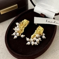 Detail of elegant gold lava texture earrings featuring hanging white pearls and vintage finish - Pearl Stud Earrings / Gold