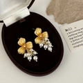 Detailed close-up of matte gold flower earrings with elegant pearl fringe in a velvet box - Gold Flower Pearl Tassel Style
