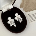 Detailed view of silver flower earrings with white pearl tassels in a vintage jewelry box - Silver Flower Pearl Tassel Style