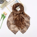 Elegant geometric print scarf in brown and yellow tones laid on a white background - Brown