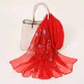 Red georgette silk scarf with floral print draped over a white elegant handbag - 160x50cm / Red Floral