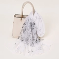 Elegant white georgette silk scarf with black floral print draped on a handbag - 160x50cm / White Floral