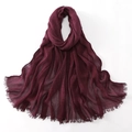 Detailed view of dark wine red hijab fabric with soft crinkle texture and frayed edges - Fuschia / 180cm x 70cm