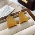 Macro detail of golden textured stud earrings with a rounded triangle design in a gift box - Curved Triangle Grainy Stud Earrings / Gold