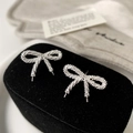 Detailed macro view of silver bow-shaped stud earrings with textured metallic finish - Silver Bowknot Stud Earrings