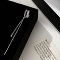 Macro detail of silver long tassel ear cuff with shimmering white zircon stones - Silver Tassel Ear Cuff