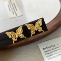 Macro detail of gold butterfly stud earrings with hollow wings and inlaid zircons - Hollow Butterfly (Gold) / Gold