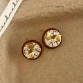 Macro shot of red resin earrings with gold butterfly inlay and sparkling zircons - Red Butterfly Stud Earrings