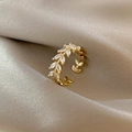 Detailed macro of golden vine leaf ring with marquise-cut zircon on silk fabric - Adjustable Open / Gold Tree of Life Ring
