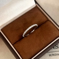 Macro shot of a silver pearl and diamond ring inside a brown velvet jewelry box - Silver