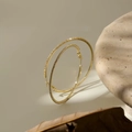 Detail of large gold hoop earrings featuring micro-set white cubic zirconia stones - 4cm Gold