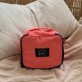 Portable coral pink nylon makeup bag with black top handle and graphic label for travel - Fluorescent Pink