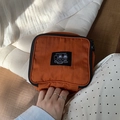 Orange canvas portable toiletry bag with cartoon patches and black zipper handle - Caramel color