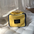 Yellow nylon travel cosmetic bag with blue trim and cartoon heart print design - Yellow