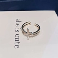 Detail of rose gold fishtail ring with pearls and micro-pave zircons on a display card - Silver