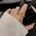Fashion gold-plated link ring with white zircon stones on a black background - Gold