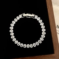 Top view of shiny silver tennis bracelet with oval cubic zirconia on black velvet tray - D-275 Silver Oval Cut Zircon Bracelet