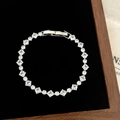 Macro view of silver tennis bracelet with square-cut zircons in a black jewelry box - D-276 Silver Square Claw Set Bracelet