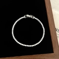 Macro detail of tennis bracelet with brilliant round cut zircons on black velvet base - D-279 Silver Small Square Zircon Bracelet