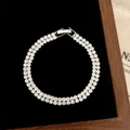 Detail of silver double-row tennis bracelet with white cubic zirconia on black velvet - D-282 Silver Double Row Round Zircon Bracelet