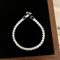 Macro detail of silver tennis bracelet with cubic zirconia on black velvet padding - D-288 Silver Single Row Round Zircon Tennis Bracelet