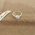Close-up of silver knot ring with multi-layer wire design and adjustable open band - Silver