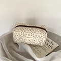 Floral makeup bag in cream and brown print with top zipper and vintage aesthetic - White