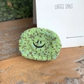 Mini green fleece coin purse with embroidered smiley face on a rustic wooden background - Green