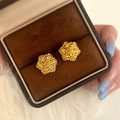 Close-up of golden rose cluster earrings in a velvet jewelry box on faux fur - Gold
