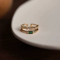 Close-up of double-layered gold ring featuring emerald green stone and zircon accents - Gold Peacock Green Zircon Double Layer Ring