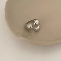 Detail view of silver triple water-drop rings on a ceramic plate with minimalist design - Irregular Triple Bead Ring (C-317)