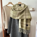 Écharpe classique à carreaux verts et beige avec franges sur un long manteau gris - Vert clair