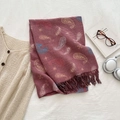 Reddish brown paisley scarf with knit texture and long tassels on white bedding background - Red