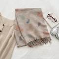 Beige cashmere-feel paisley scarf with stripes and tassels in a lifestyle flat lay - Tan