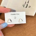 Macro shot of silver geometric triangle studs with glitter inlay and beaded trim - Silver Stud Earrings / Silver