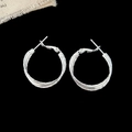 Detail view of silver double-layered round hoop earrings with textured finish on black backdrop - Diameter 2.5cm / Silver Color 2.5cm