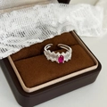 Detail of silver lace ring featuring an oval red zircon stone on vintage velvet - Silver with Rose Red Zirconia
