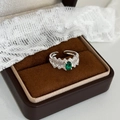 Detail of silver mesh ring with oval green stone on white lace and gift box - Silver with Green Zirconia