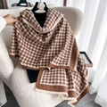 Classic houndstooth knit scarf in brown and white with tassel fringe on a hanger - Brown and White Patchwork